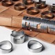 Illustration for article titled Stackable Chess Pieces Hide a Rolled Up Leather Board Inside